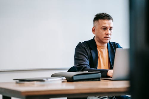 Photo Of Man Engaged In His Laptop