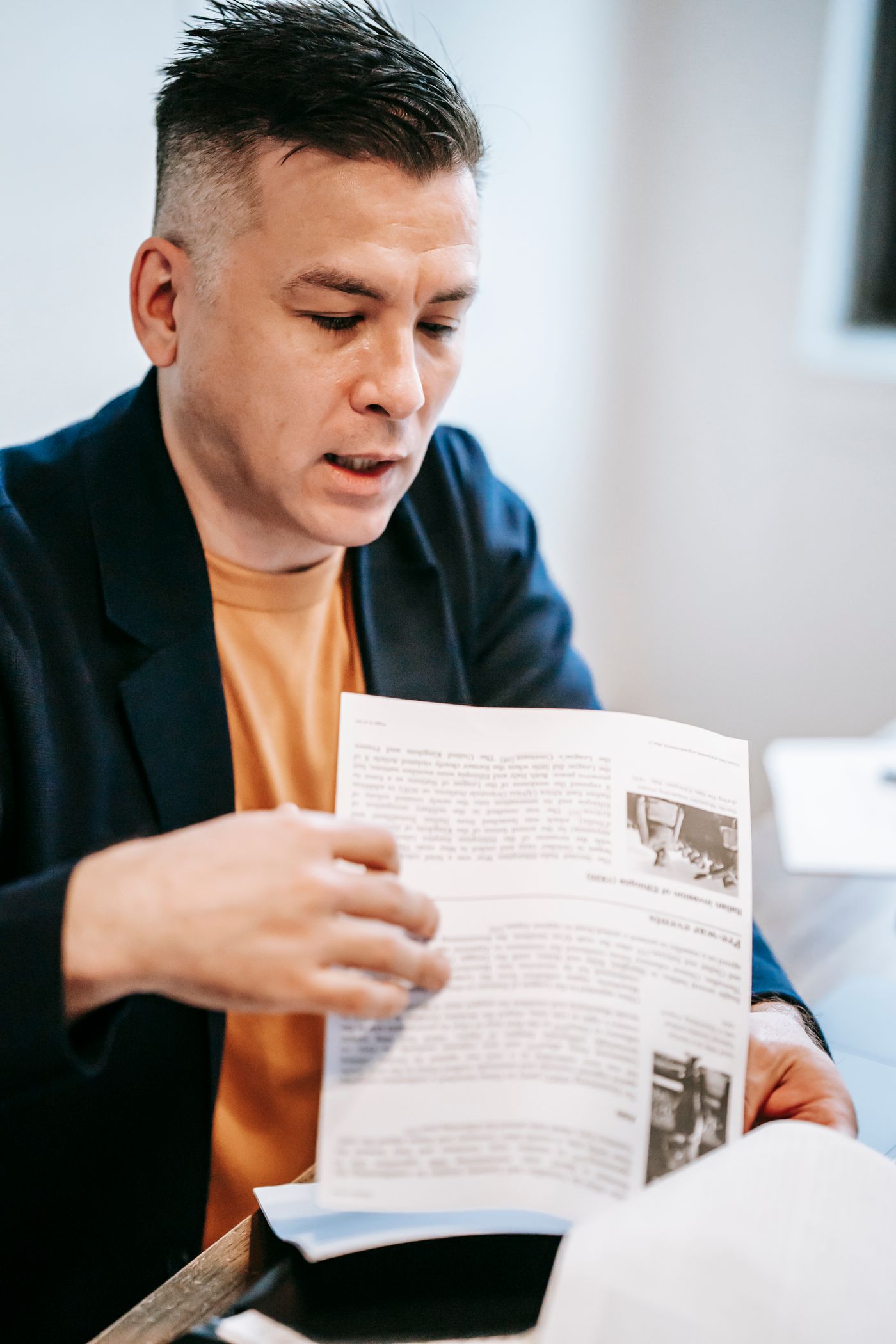A school leader reviewing programme documents at a desk