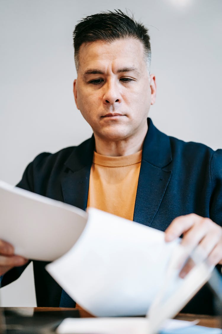 Photo Of Man Reviewing Paperworks