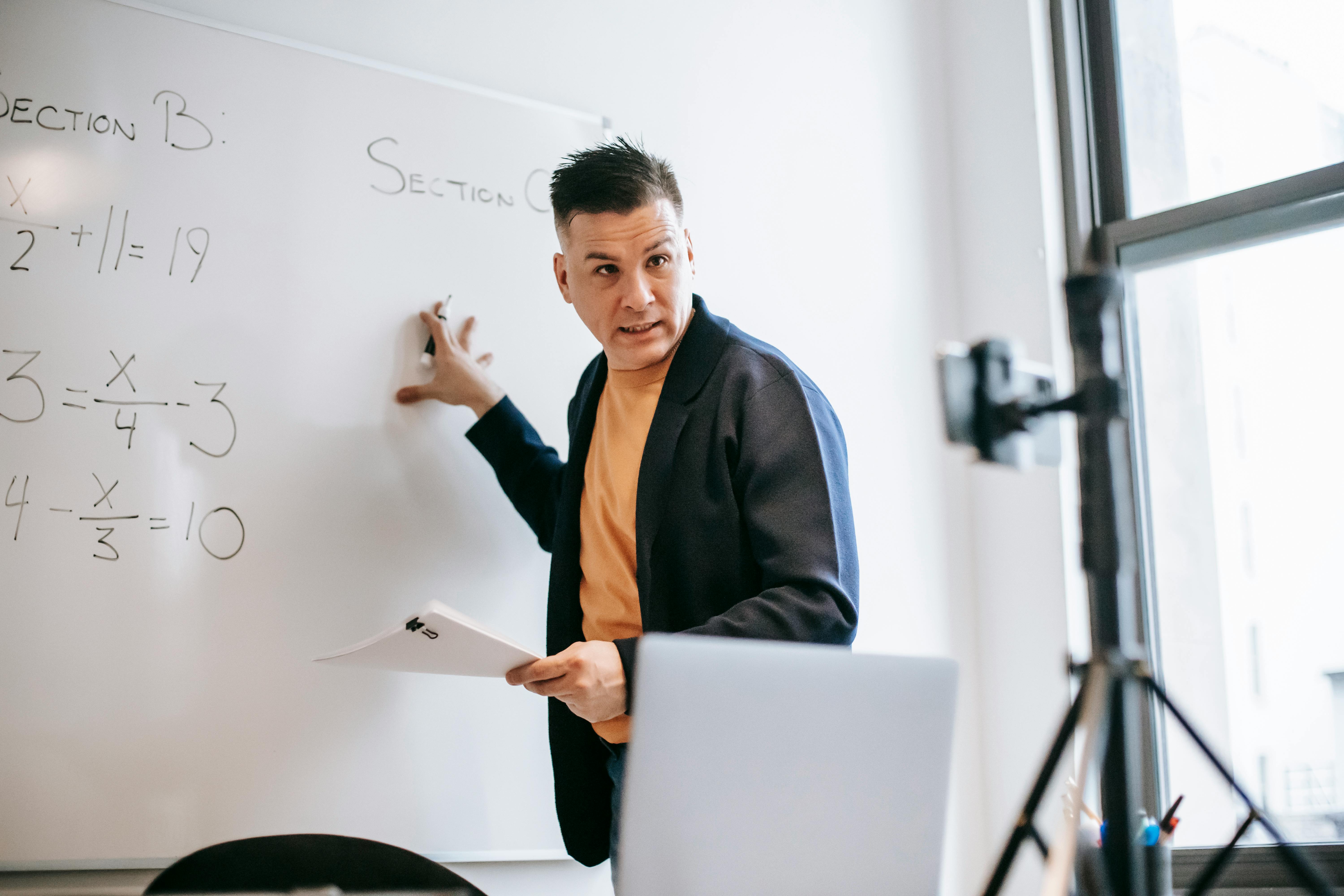 photo of man teaching via smartphone