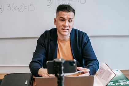 A professional educator conducting an online class, engaging with students via video call — photo by Vanessa Garcia on Pexels