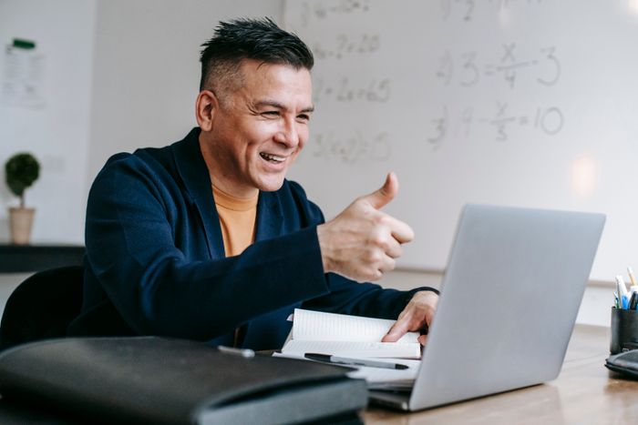 Creative director giving a thumbs up on a call — photo by Vanessa Garcia on Pexels
