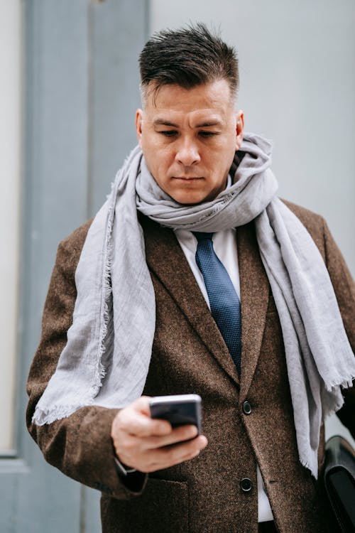 Photo Of Man Using His Smartphone 