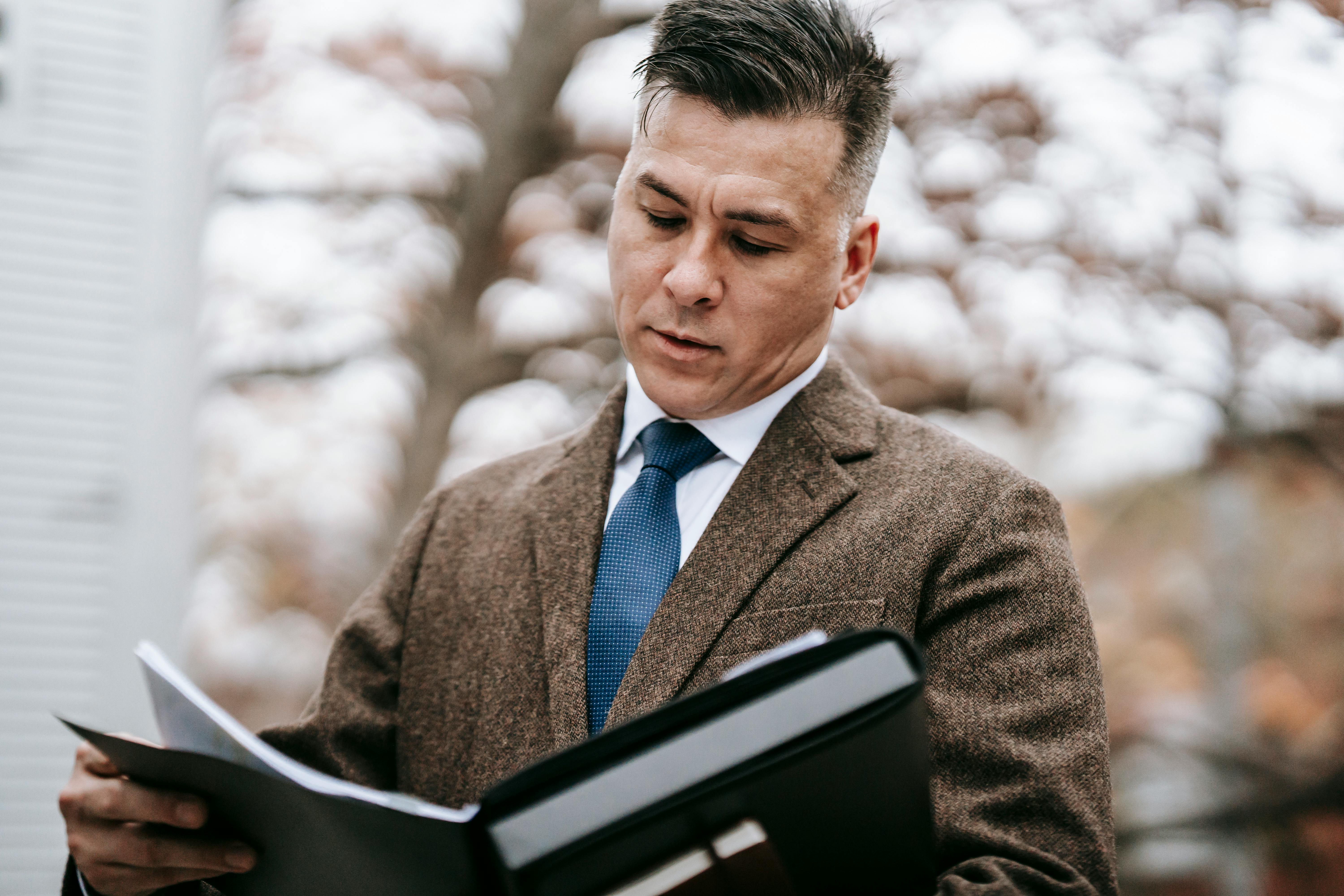 photo of man wearing brown suit