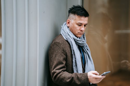 Photo Of Man Using Smartphone