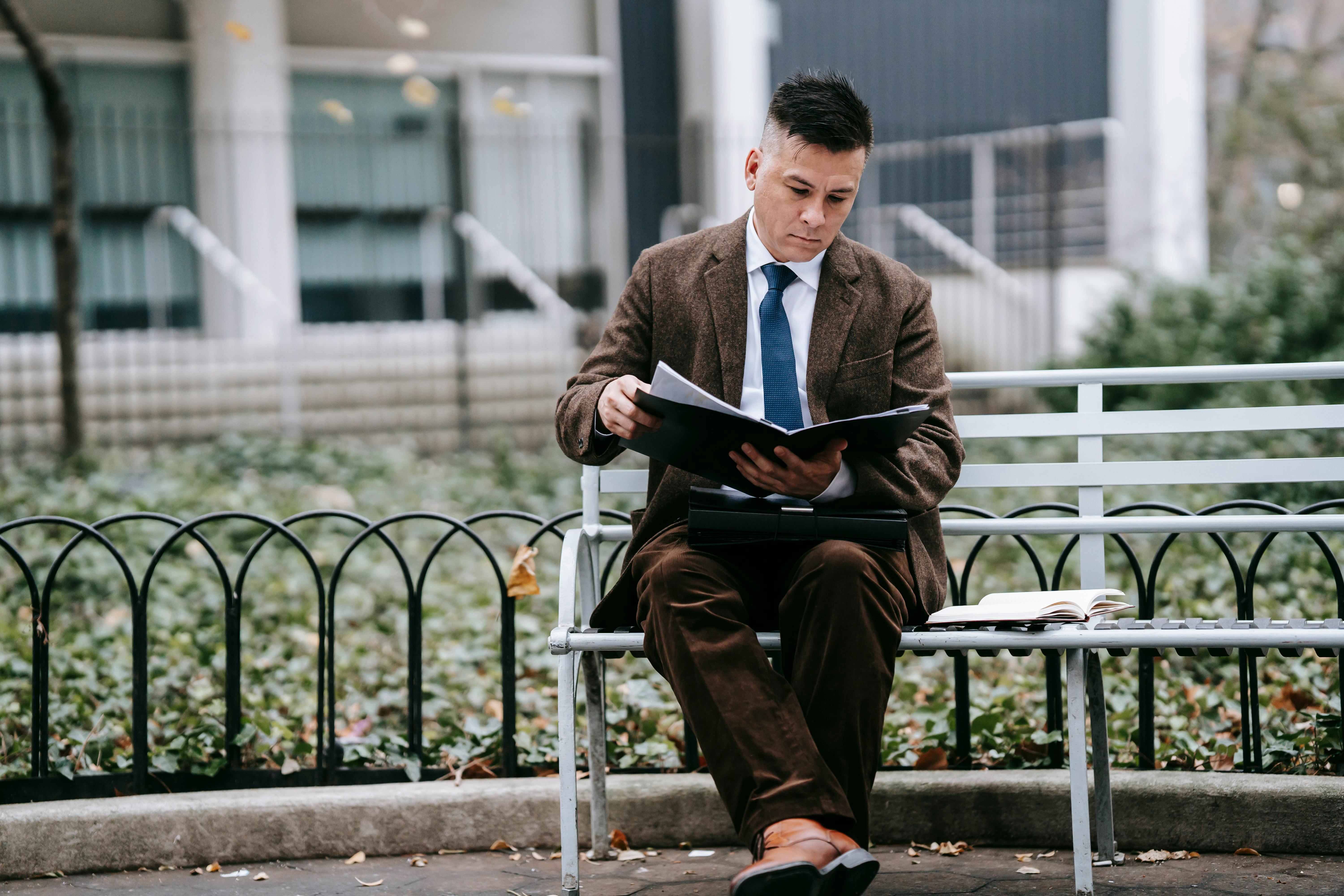 photo of man reeading the documents