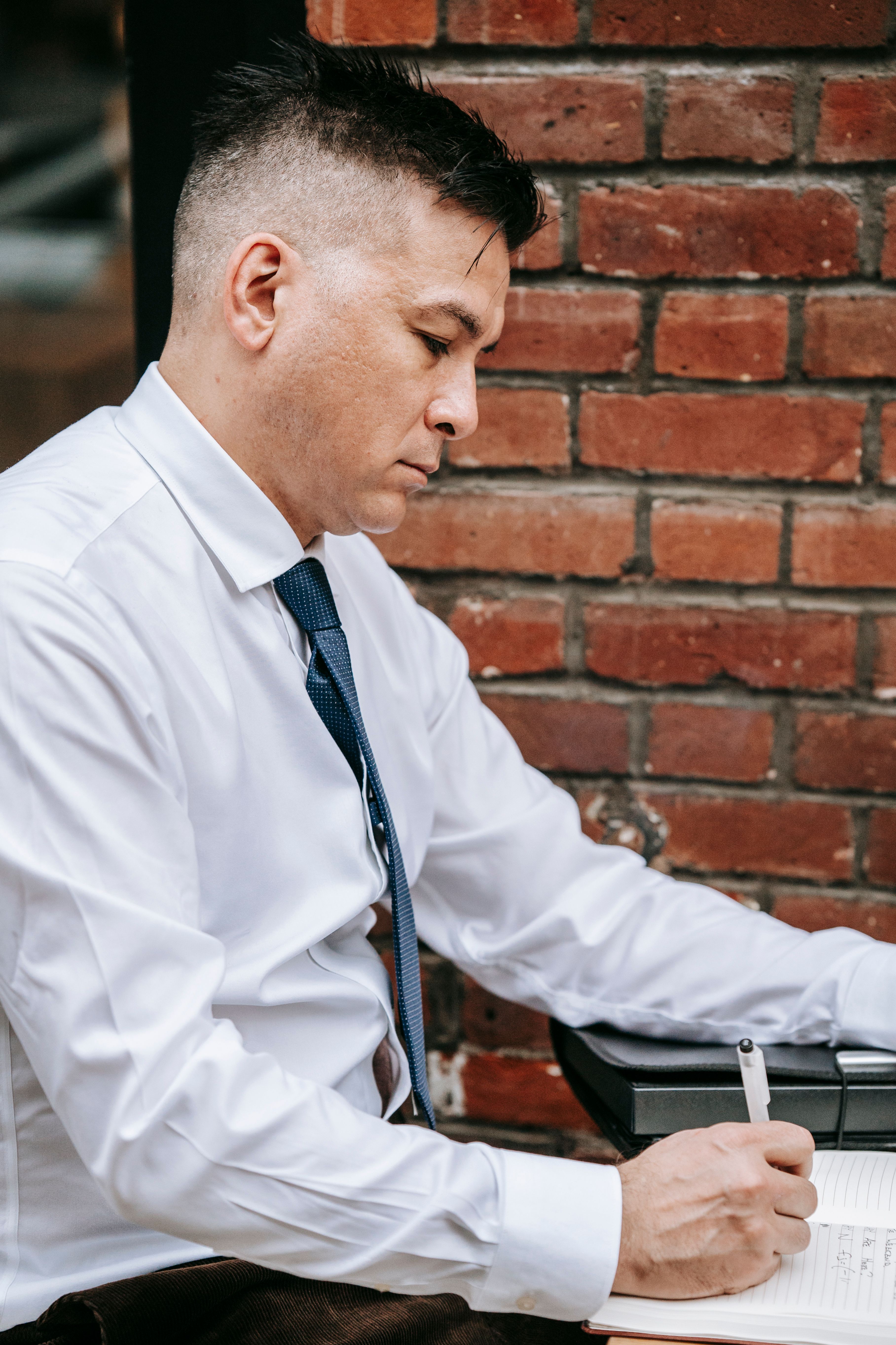 Photo Of Man Writing On White Paper · Free Stock Photo