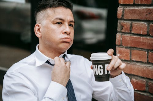 Photo Of Man Adjusting His Necktie