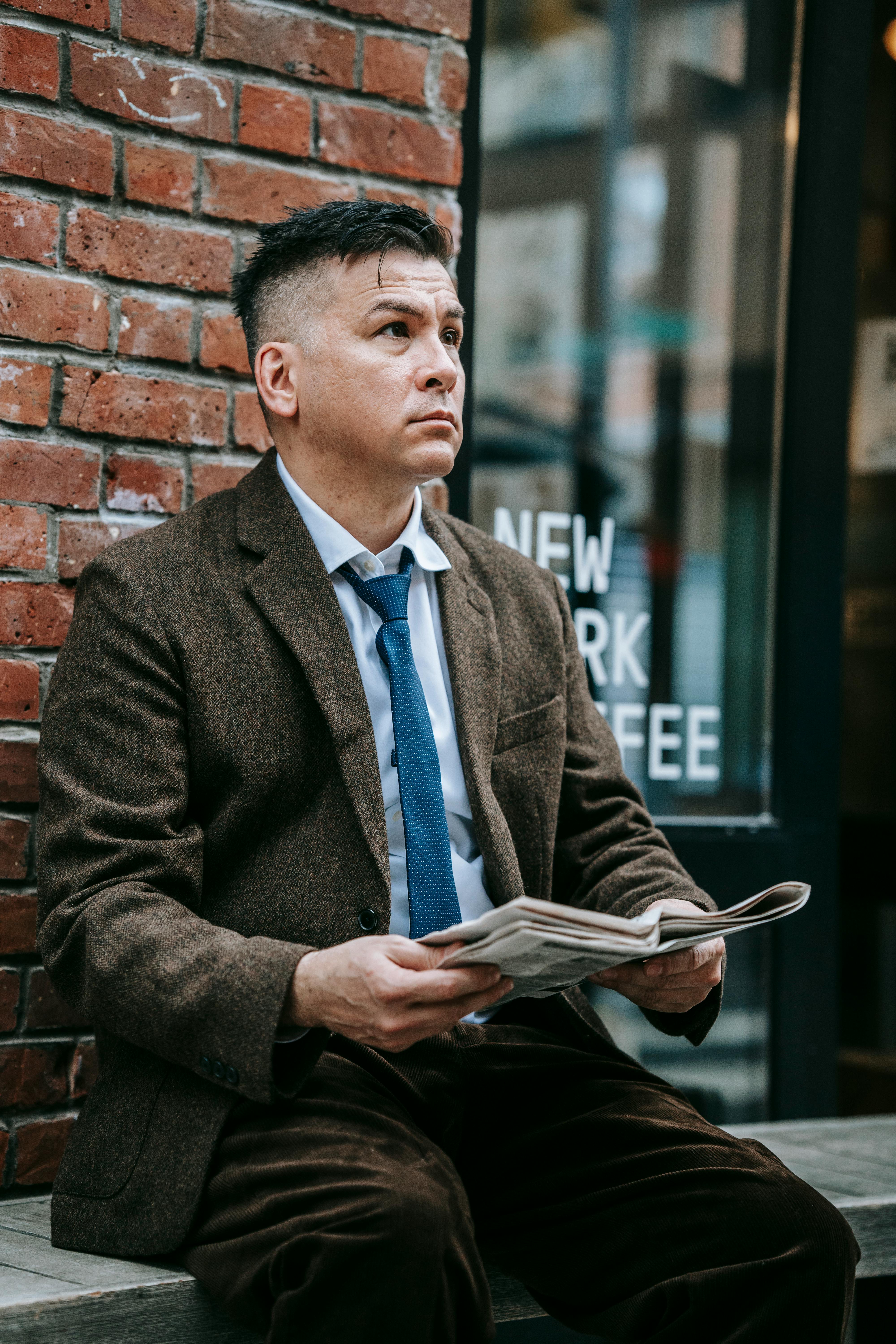 photo of man wearing brown coat