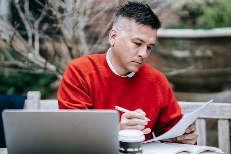 Photo Of Man Reviewing Documents