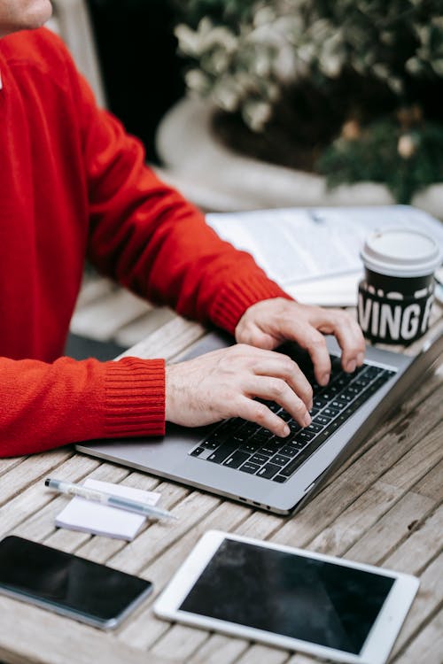 Photo Of Person Typing On His Laptop