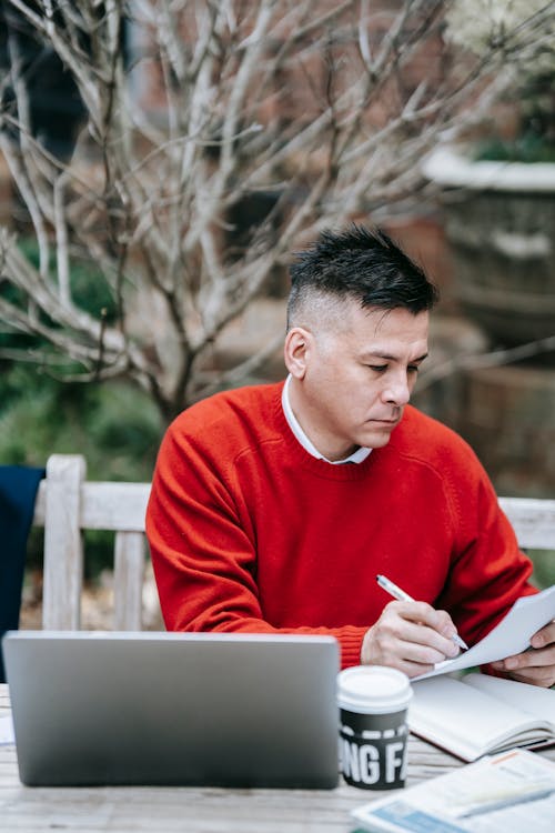 Photo Of Man Looking At Paper