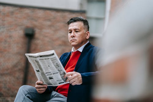 Photo Of Man Reading Newspaper