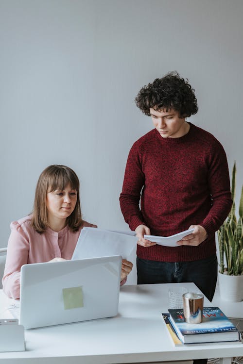 Free A Man and a Woman Looking at Documents Stock Photo