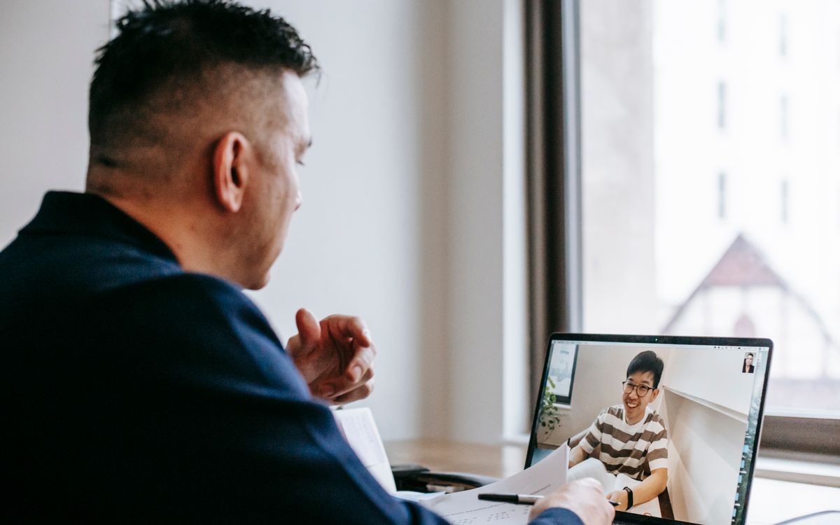 Professional video call between colleagues in an office setting, fostering connection and collaboration.