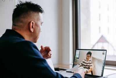 Two people meeting over a video call at a desk — photo by Vanessa Garcia on Pexels