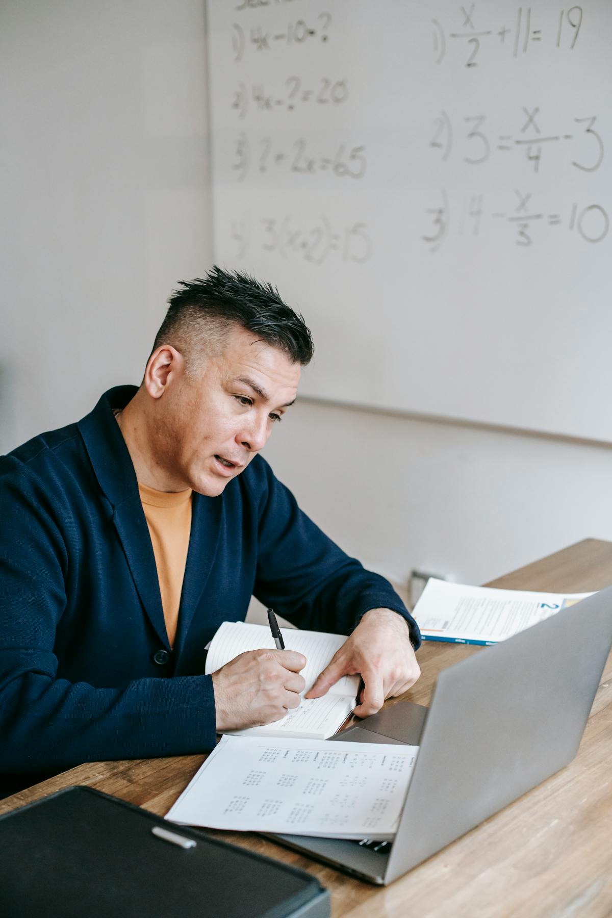 Laptop on a desk showing a lo-fi music stream while a person studies