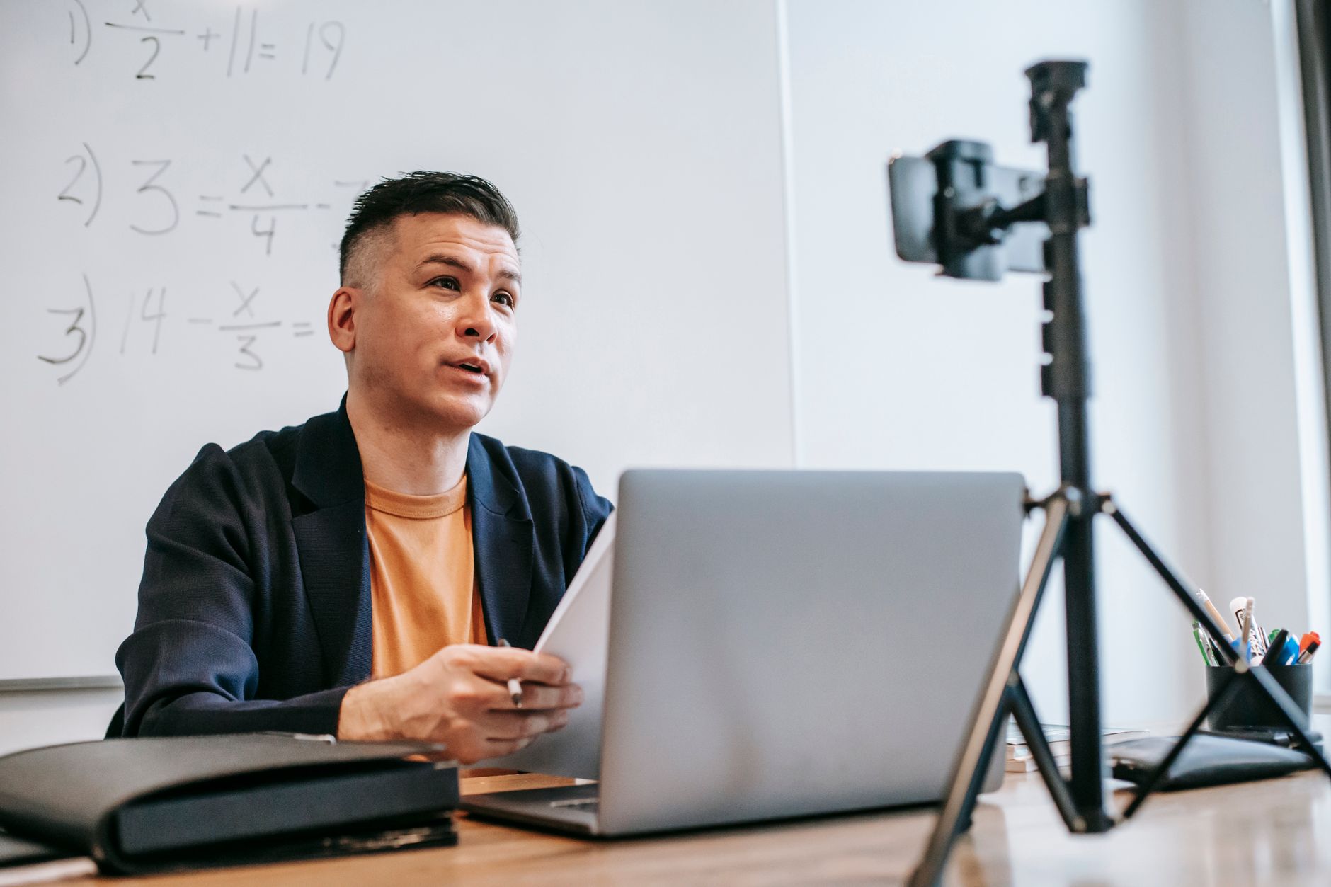 Open laptop playing a video lecture — the free layer of the aesthetics education economy