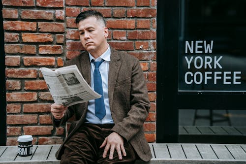 Photo Of Man Reading Newspaper