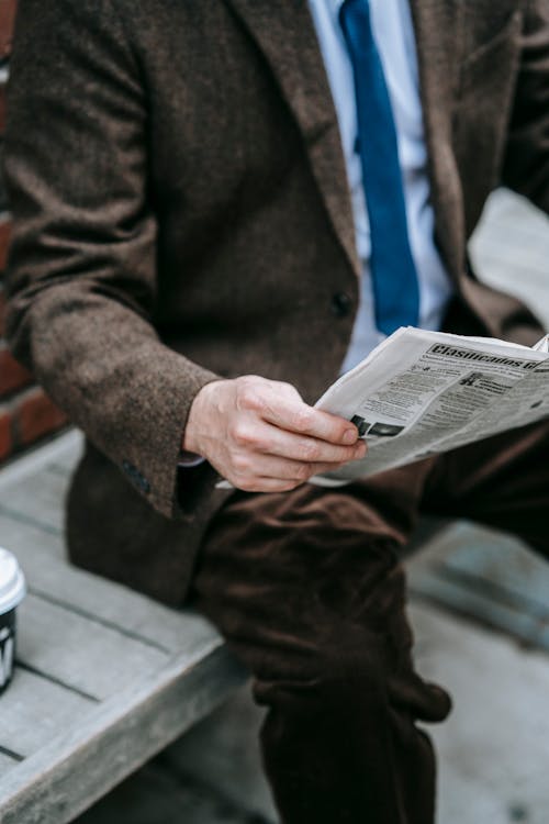 Photo Of Person Holding Newspaper
