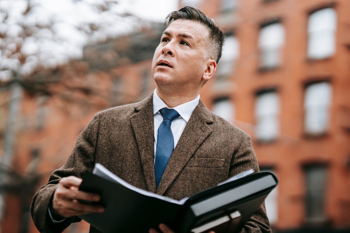 Photo Of Man Holding Book 