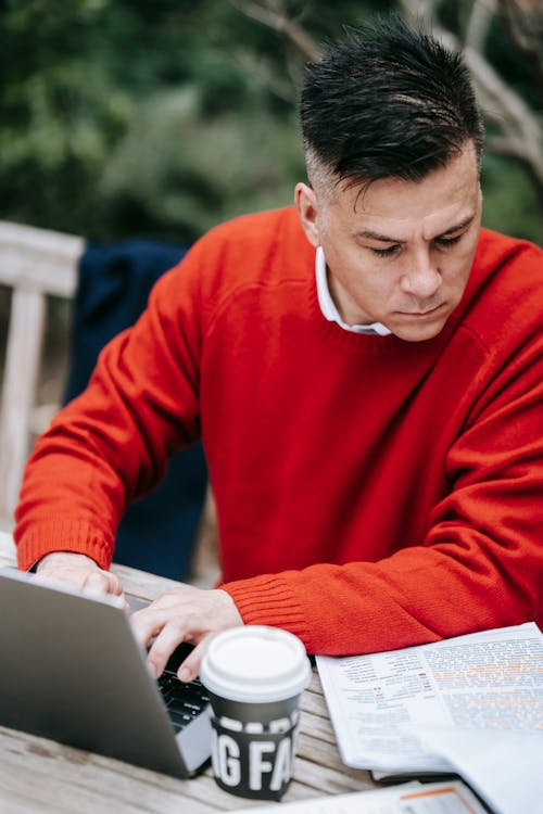 Man in Red Sweater Using Macbook
