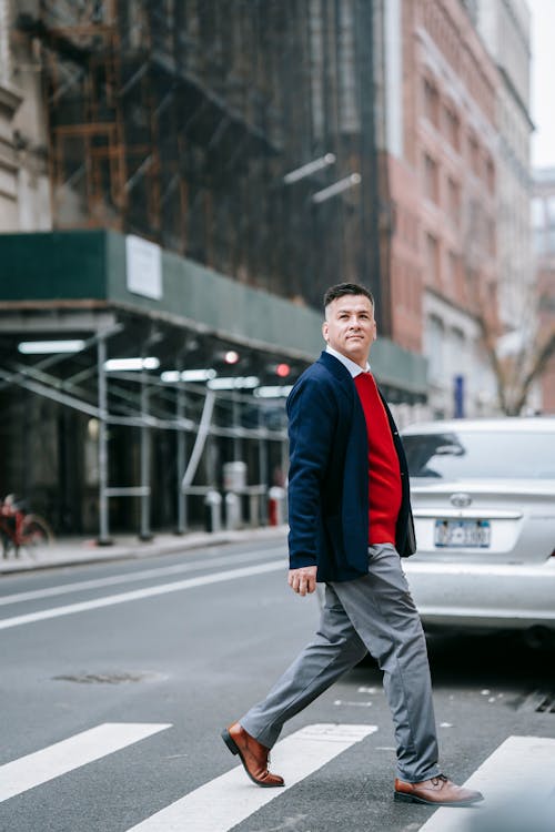 Photo Of Man Walking On A Pedestrian Lane