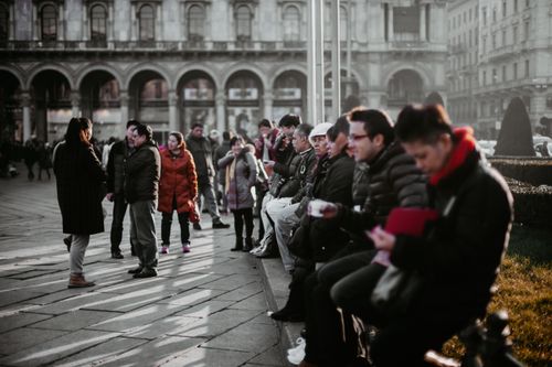 Free A group of people in winter attire gathering in a street scene in Milan, Italy. Stock Photo