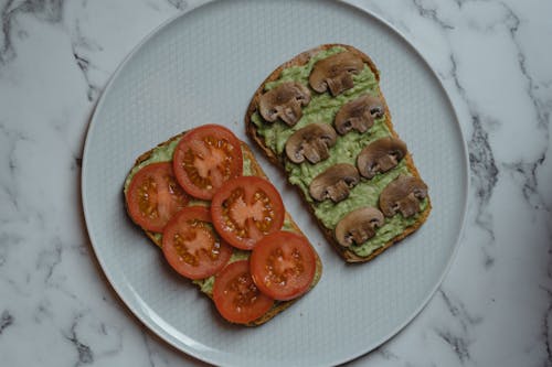 avocado toasts with tomatoes and mushrooms on top