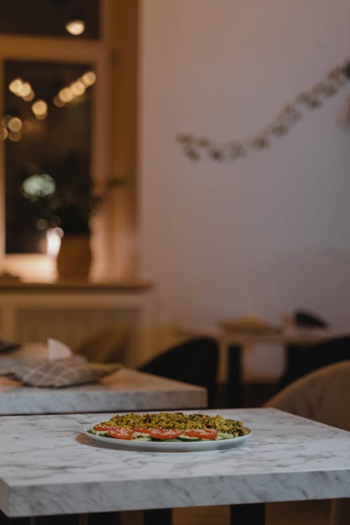 A Ceramic Plate with Food on the Table