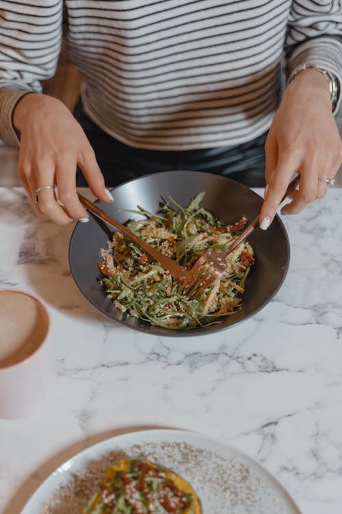 Person Eating Vegetable Salad