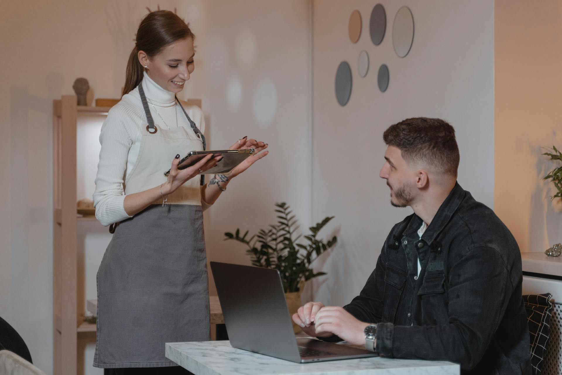 A Waitress Talking to a Customer at a Restaurant