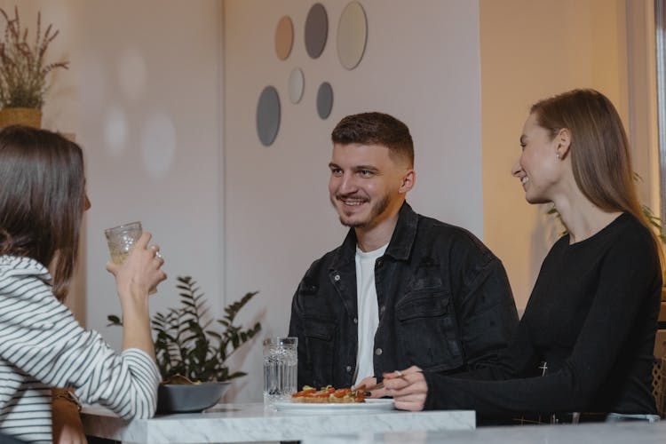 Friends In A Restaurant Eating Together 