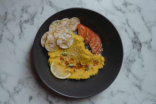 Free A Hummus with Sliced Tomatoes on the Side Stock Photo