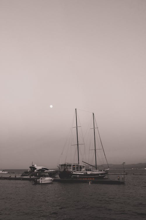 A Grayscale Photo of a Boat on the Sea