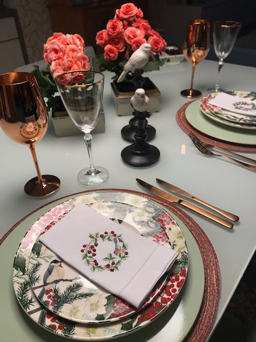 A Fine Dining Set Up with Plates and Wine Glasses