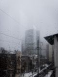 A foggy city skyline through a rain-covered window — photo by Artyom Hunter on Pexels