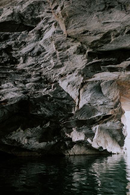 Explore the intricate rock formations and serene waters in this captivating cave scene.