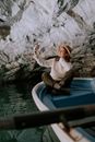 A Woman Taking Selfie while Sitting on the Boat