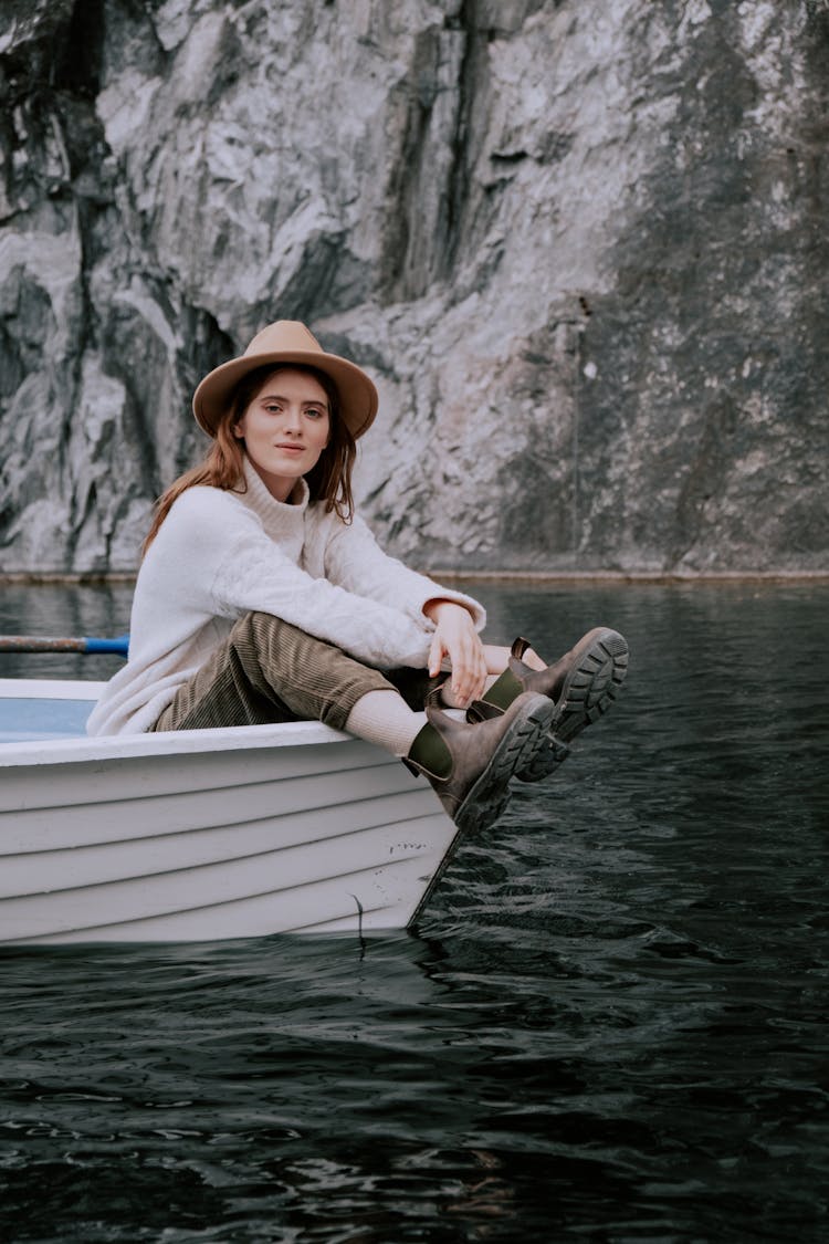 A Woman In White Sweater Sitting On The Boat