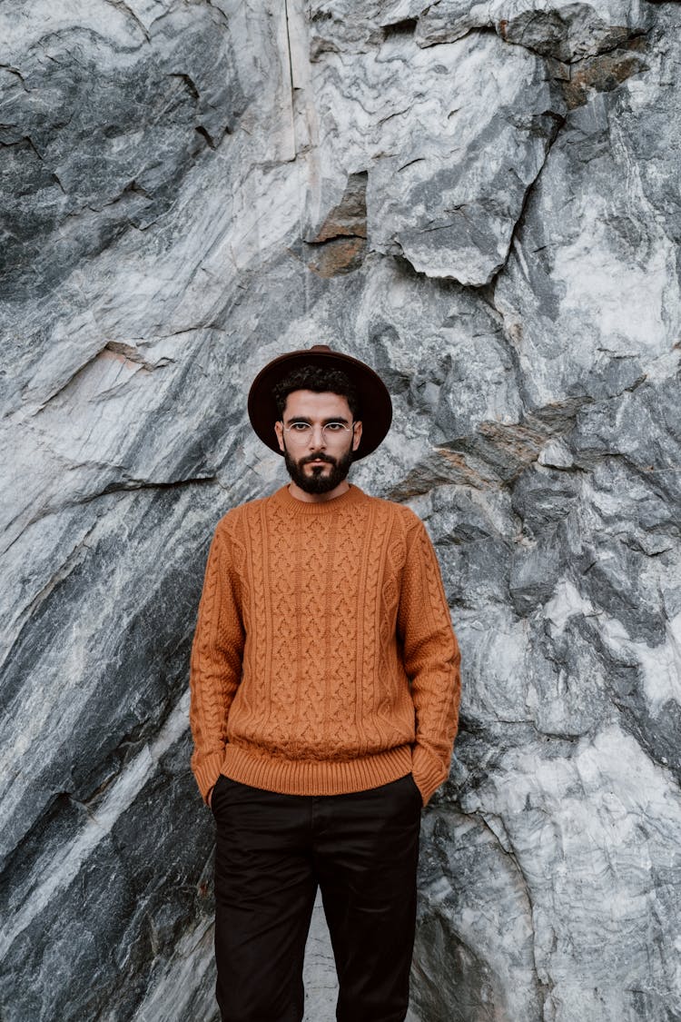 A Man Standing In Front Of Granite Rocks