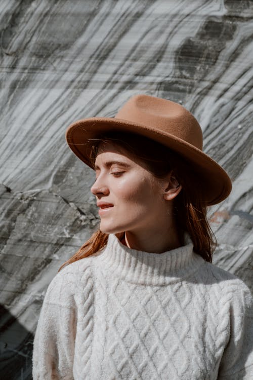 Woman Wearing Brown Fedora Hat and White KNitted Sweater