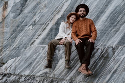 A Couple Sitting on Granite Rocks