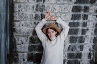 A Woman Standing on Front of a Granite Wall