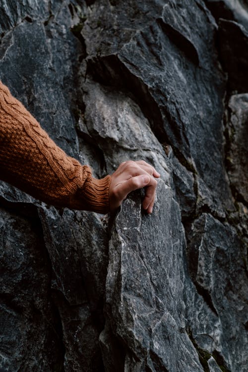 Free Man Hand on Rock Stock Photo