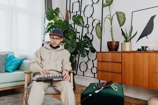 A Man Playing an Electric Piano Connected to a Table Computer