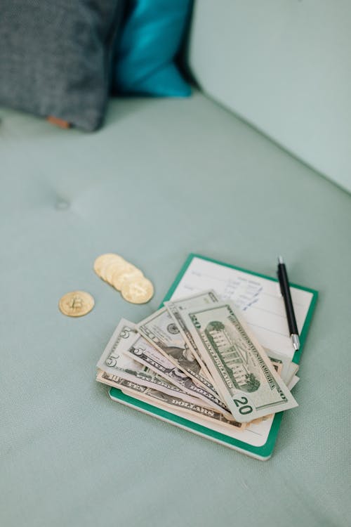 American Dollars and Coins on a Notepad