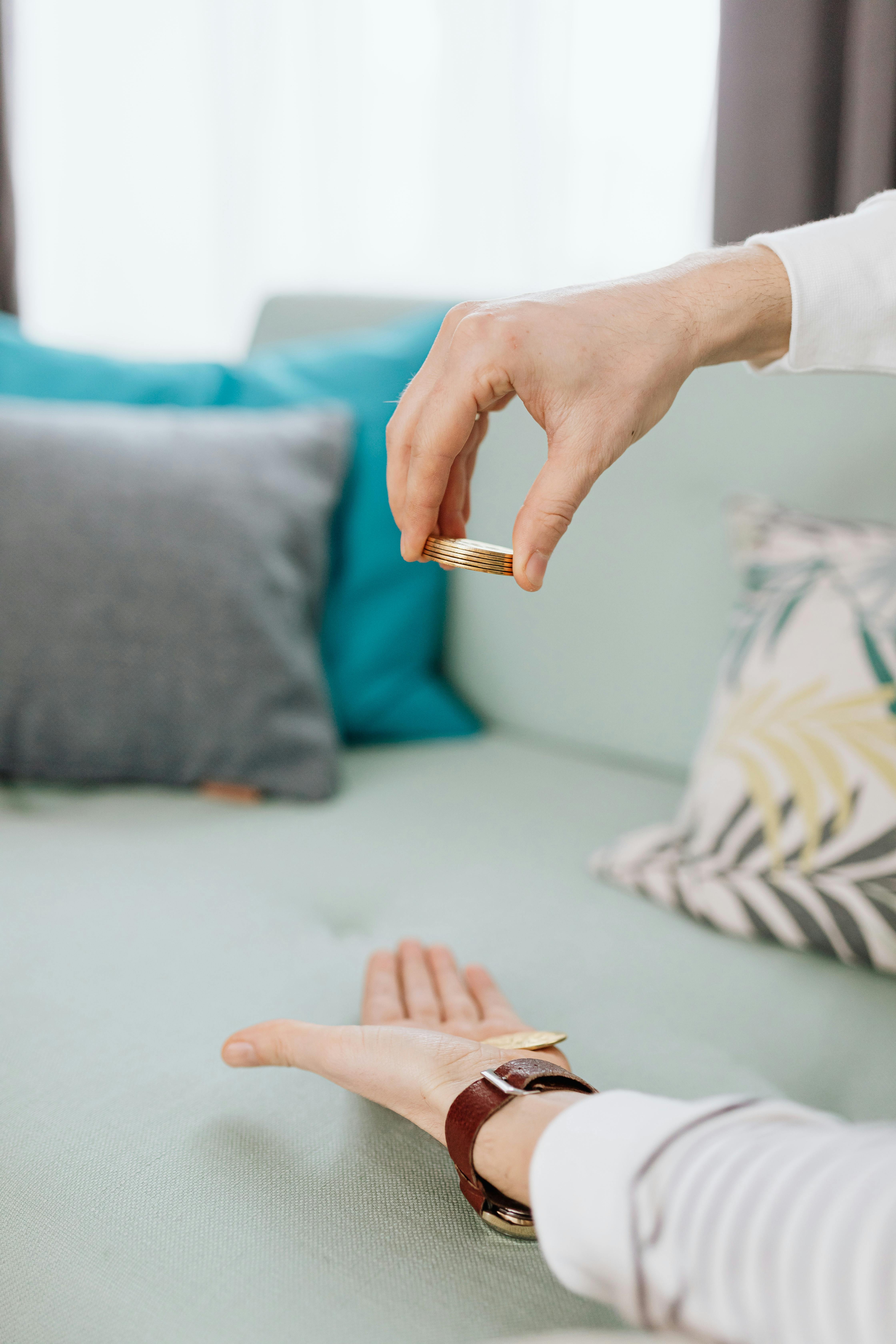 hand holding stacked of gold coins