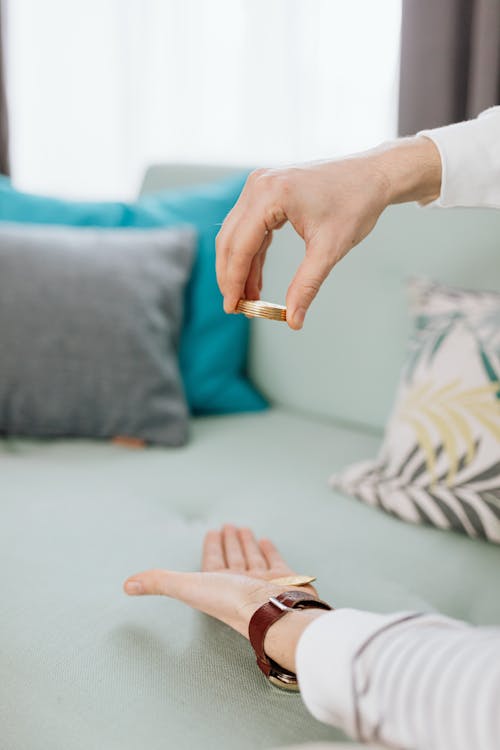 Hand Holding Stacked of Gold Coins 