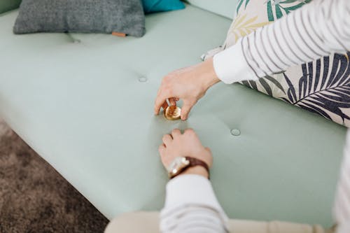 Stacked of Gold Coins on Green Couch 